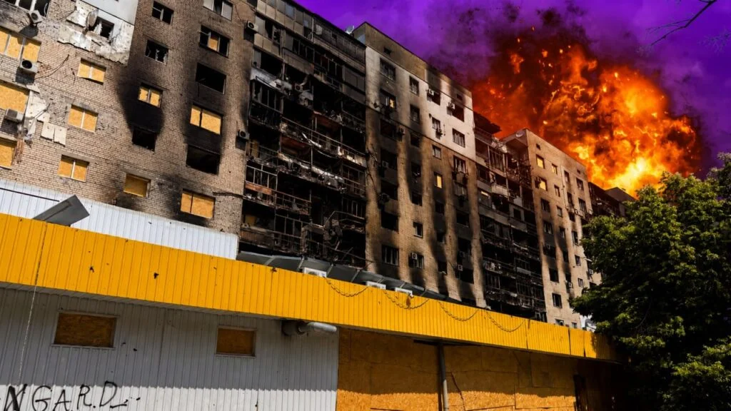 Обгоріла багатоповерхівка з полум’ям за дахом